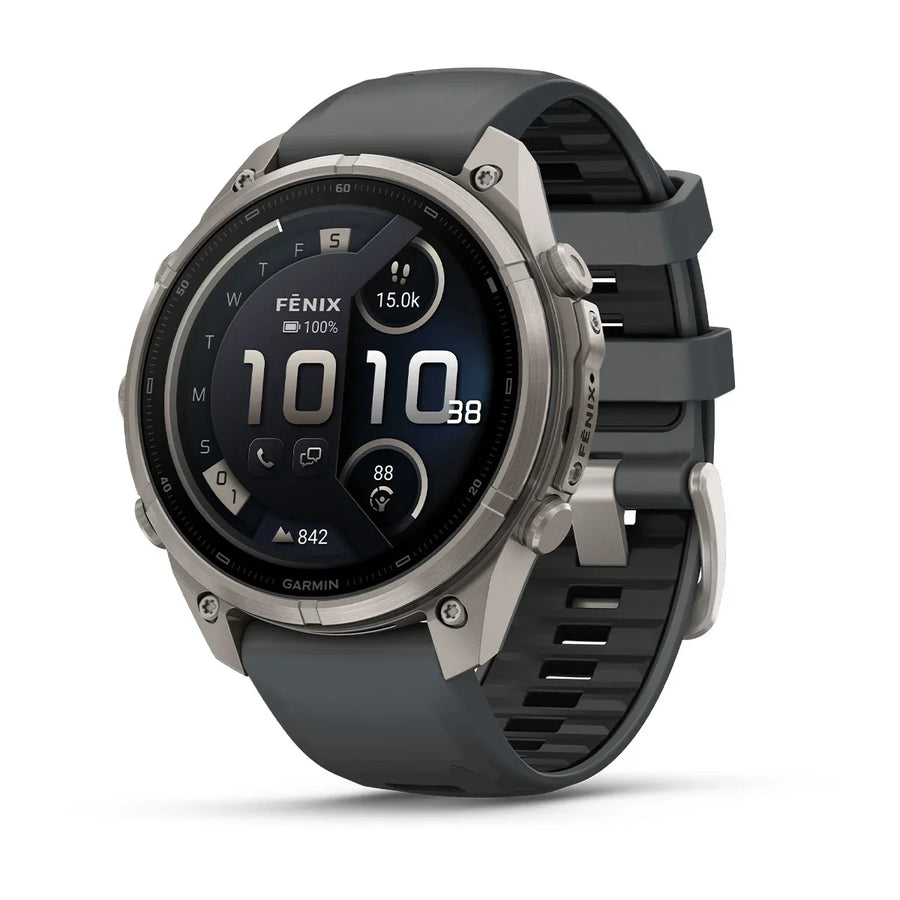 A Garmin smartwatch with a dark gray silicone strap and a silver-toned titanium case, shown at a three-quarter angle on a white background.
