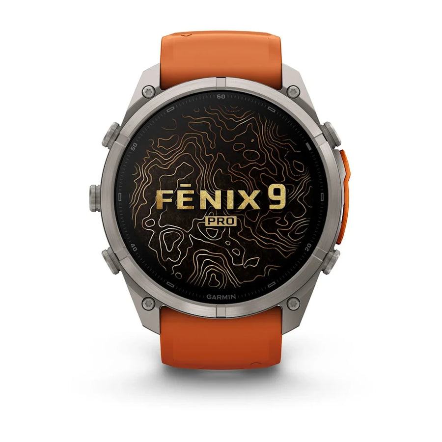 A Garmin Fenix 9 Pro smartwatch with a round silver-toned metal case, a black display screen featuring gold topographic lines and 'FENIX 9 PRO' text, and an orange silicone strap, shown against a plain white background.